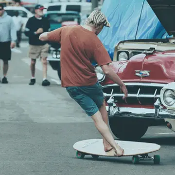A guy doing stepping on a big Hamboard deck